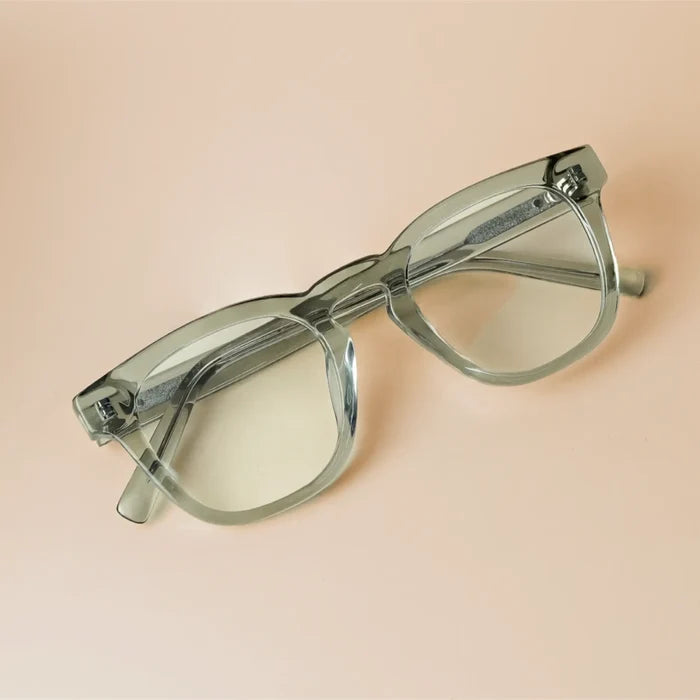Sea Salt Grey || Grey acetate square prescription eyeglasses with keyhole bridge and clear lenses on beige surface