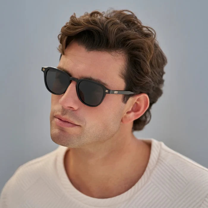 Black / Grey || Men's Round Prescription Sunglasses with Black Frame and Grey Lenses worn by a man in natural light