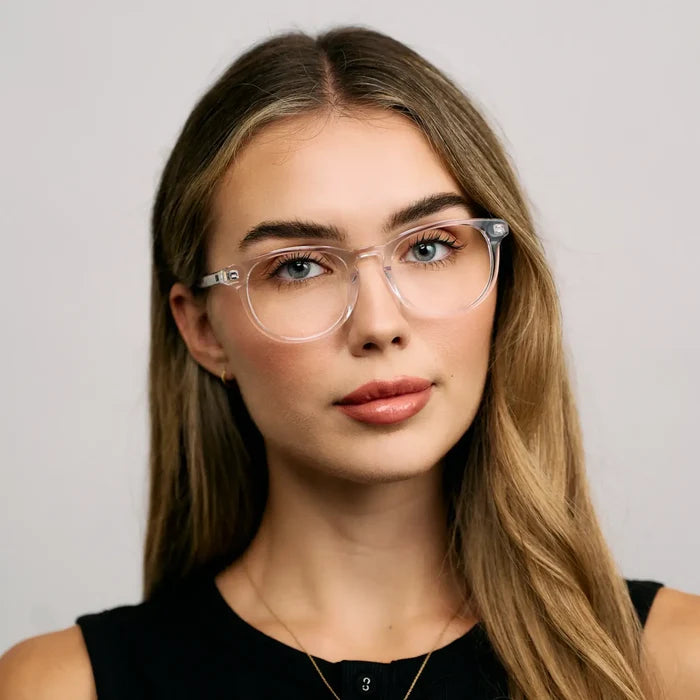 Clear || Model wearing Women's Retro-Inspired Oval Prescription Glasses with a Clear Acetate Frame and Clear Lens
