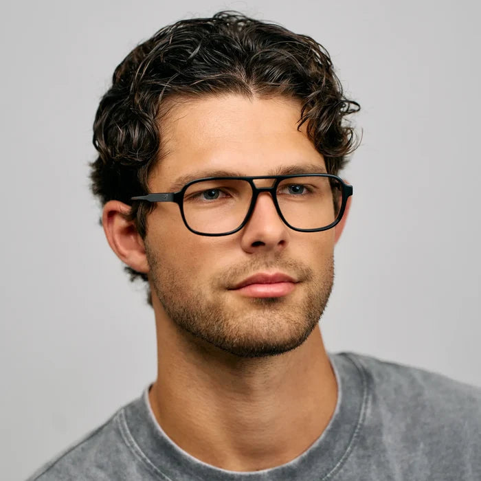 Black || Side view of aviator prescription glasses with thin black frame and flat top bridge worn by man indoors