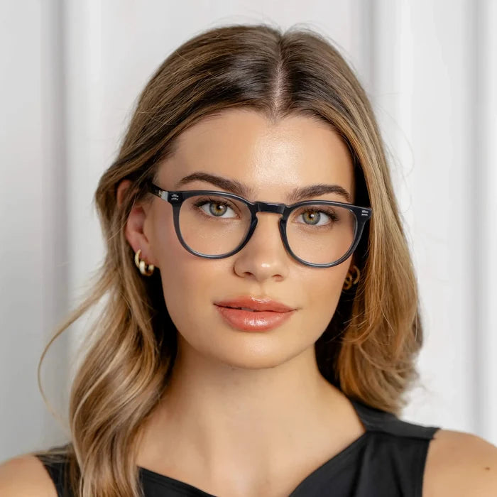 Crystal Steel Blue || Prescription eyeglasses with round frame and crystal steel blue acetate frame worn by woman indoors in natural light