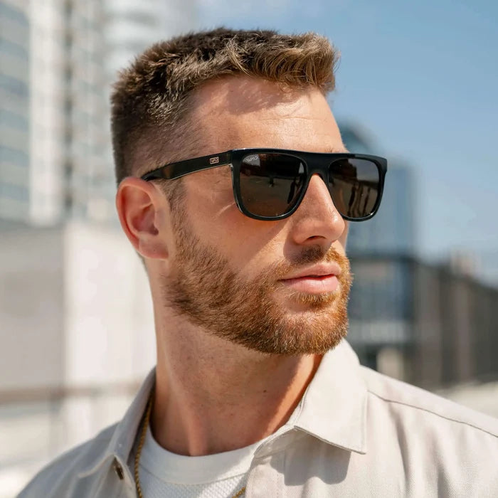 Black / Amber || Model wearing Men's Square Flat-Top Prescription Sunglasses with Black Frame and Brown Lens