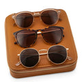 Brown Case || Three stylish sunglasses neatly arranged on a brown faux leather zippered case with white stitching details