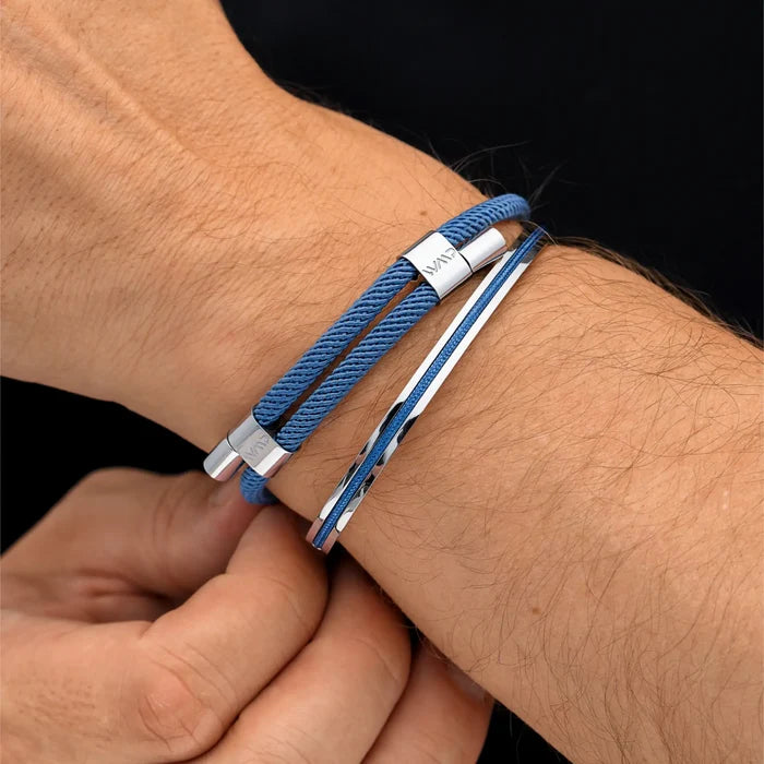 Denim Blue / Silver || Blue rope bracelet paired with sleek silver polished bangle on wrist against black background
