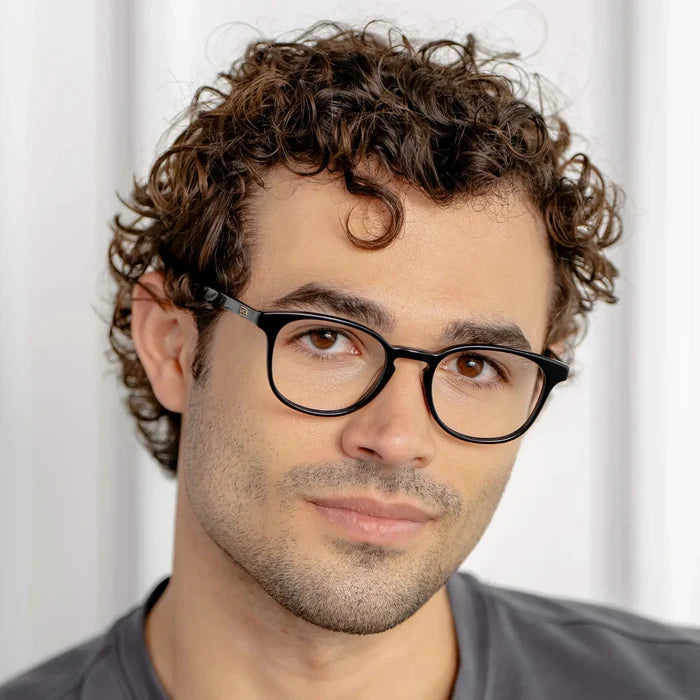 Black || Miles black round blue light glasses with lightweight frame worn by man with curly hair
