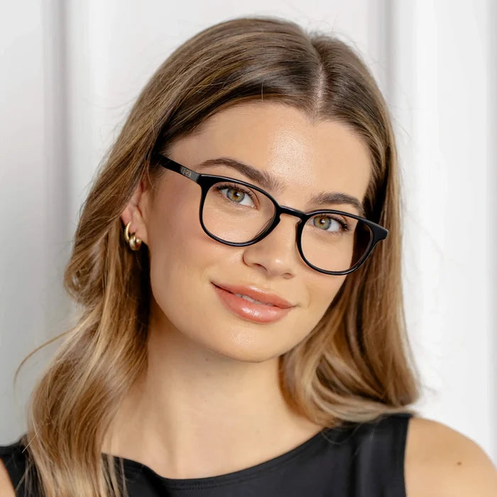 Black || Miles black round blue light glasses with thin frame worn by woman with long hair and gold earrings