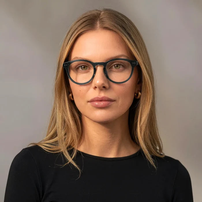 Crystal Blue || Woman wearing Round prescription eyeglasses with translucent blue acetate frame and keyhole bridge