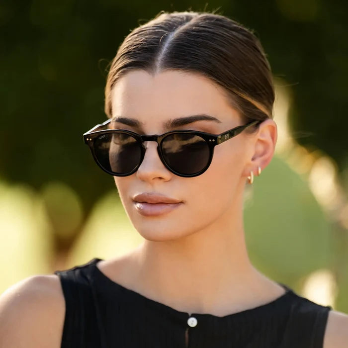 Black / Grey || Black Round Frame Prescription Sunglasses with Grey Lenses worn by a women outdoors