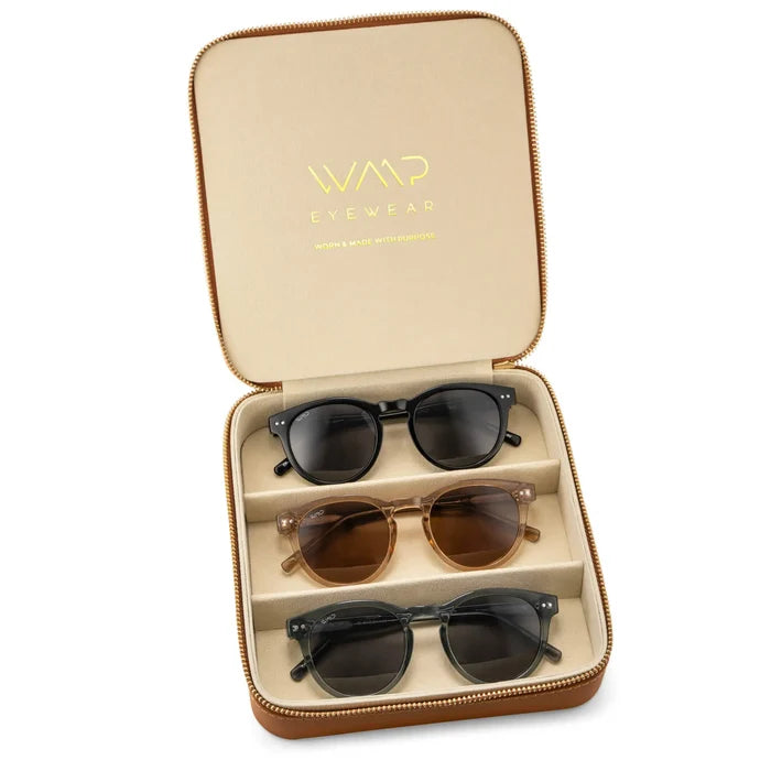 Brown Case || Three pairs of sunglasses in a tan zippered case with gold embossed logo on the lid.
