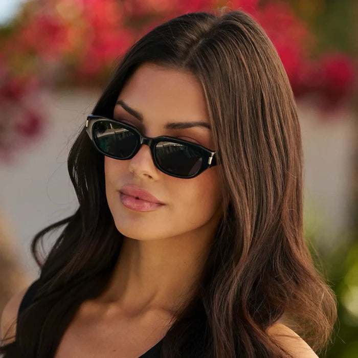 Black / Grey || Women's Oval Prescription Sunglasses with Black Frame and Grey Lenses worn by a woman outdoors