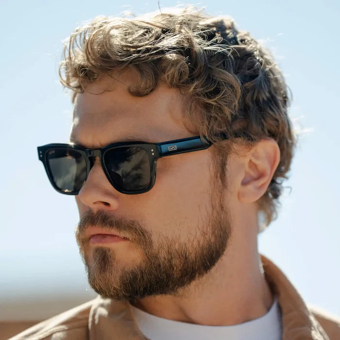 Model wearing Men's Geometric Rectangular Prescription Sunglasses with Black Acetate Frame and Amber Prescription Lens