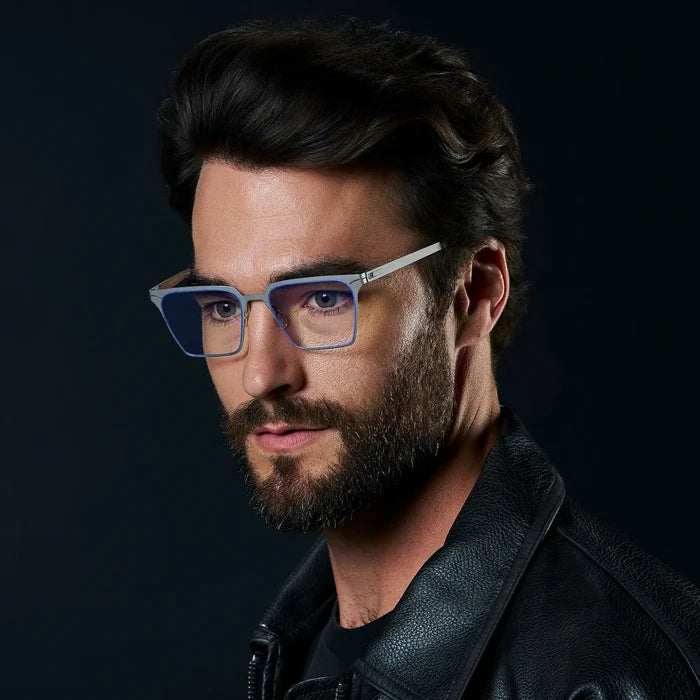Gravity Grey || Zev blue light glasses with slim silver metal frame and rectangular lenses worn by bearded man in black jacket